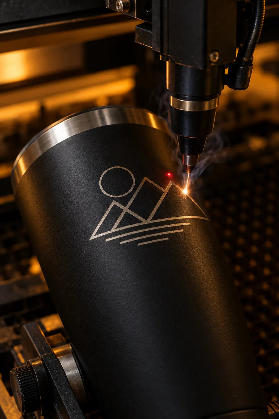 Laser engraving a geometric design into a black tumbler